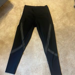 Black leggings with insert mesh panels all around the leg. Size small.